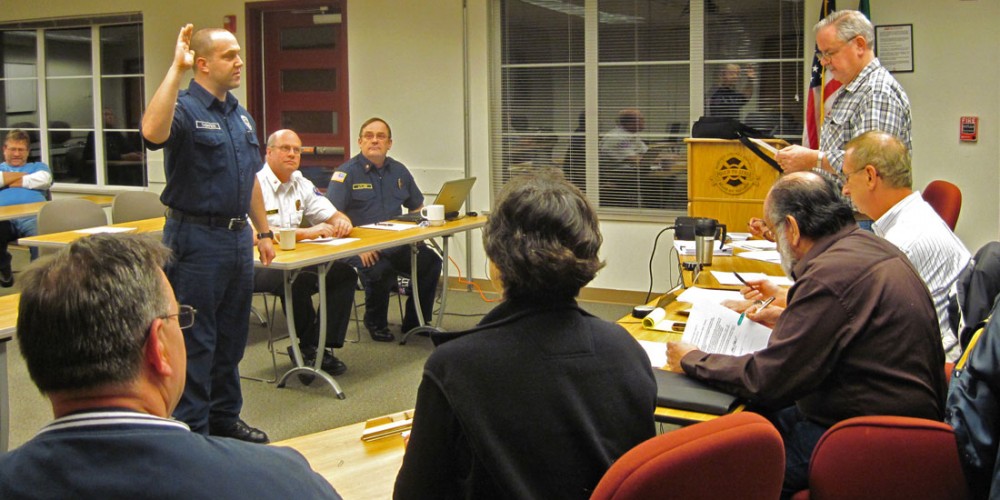 Matt Thompson takes his oath in front of the Board of Fire Commissioners