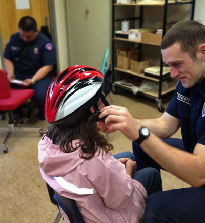 NKF&R staff fit third graders' helmets today at Suquamish Elementary